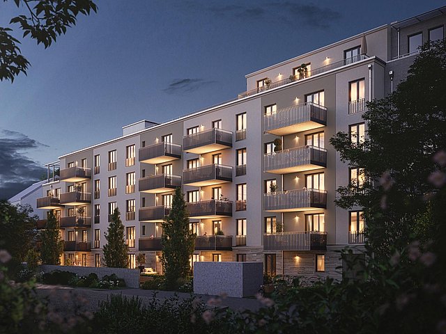 Panaoramaansicht einer Wohnanlage bei Nacht mit hell erleuchteten Fenstern